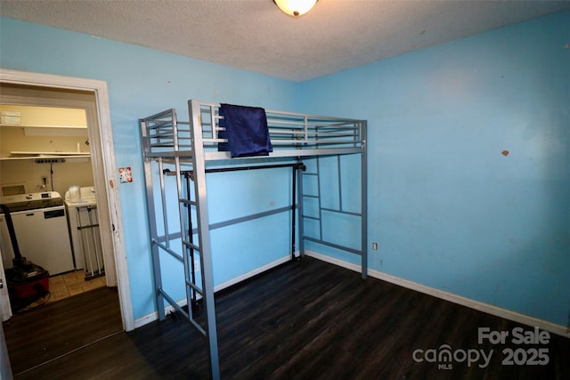 unfurnished bedroom featuring dark wood finished floors, a textured ceiling, and baseboards