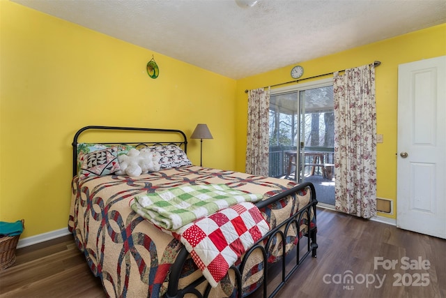bedroom with baseboards, wood finished floors, access to exterior, and a textured ceiling