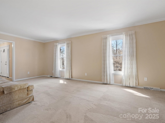 unfurnished living room featuring a wealth of natural light, visible vents, and carpet flooring