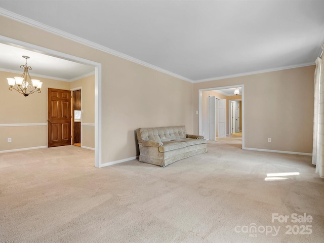 unfurnished room with a chandelier, ornamental molding, carpet, and baseboards