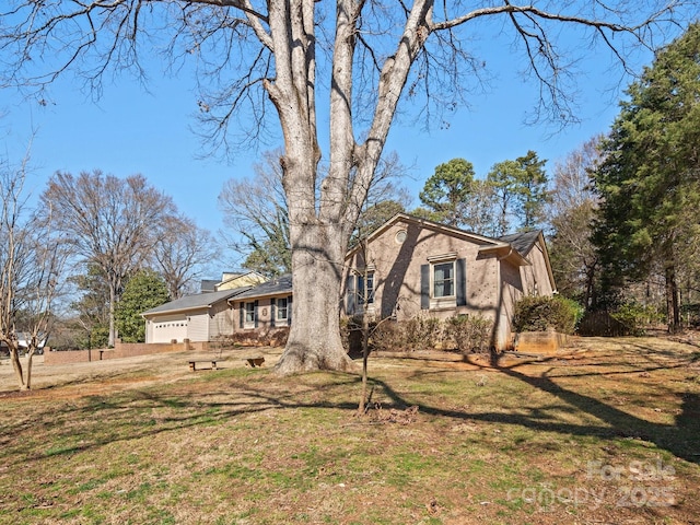 view of front of home with a front yard, brick siding, and an attached garage