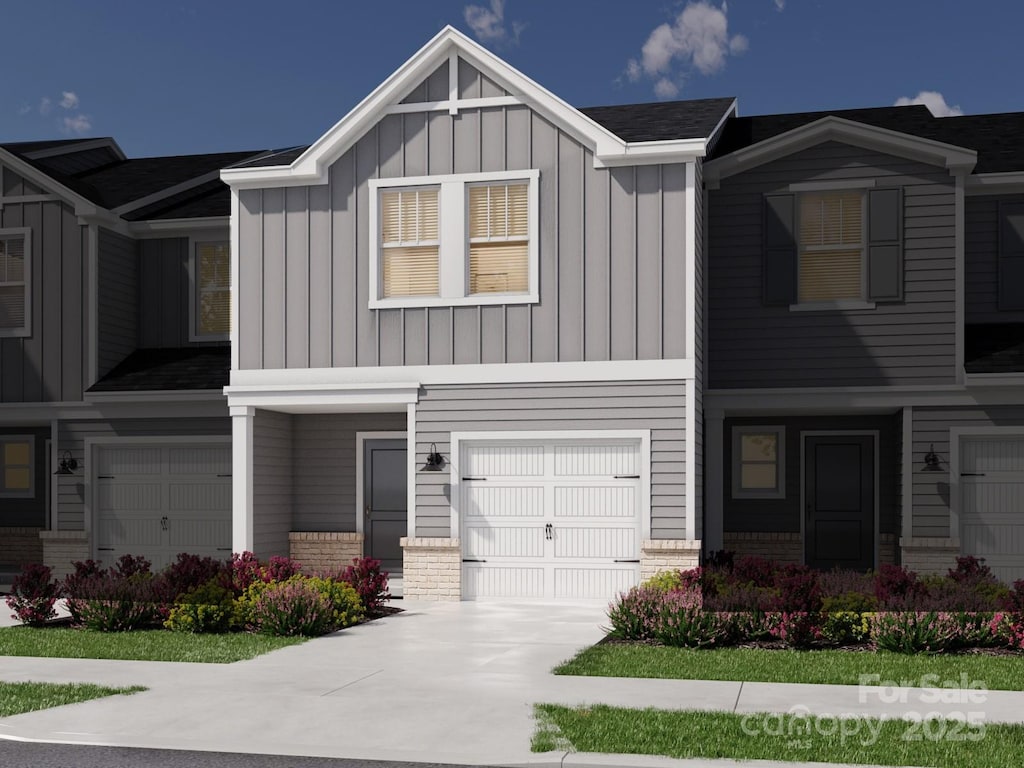 5017 Kellaher Pl, Charlotte, NC 28216 - view of property with a garage, board and batten siding, and brick siding