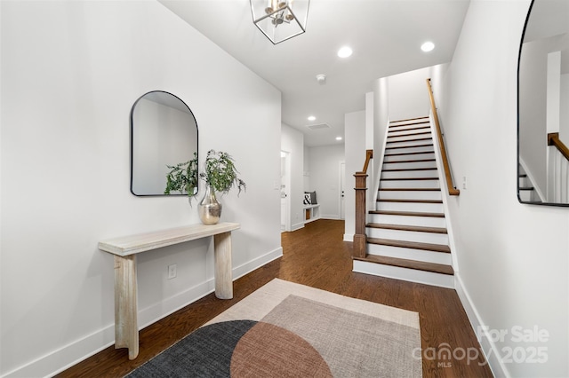 entryway with recessed lighting, stairway, baseboards, and wood finished floors