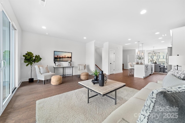 living room featuring baseboards, dark wood-style flooring, and recessed lighting