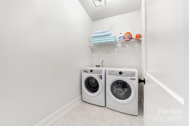 laundry area with laundry area, washing machine and dryer, baseboards, and marble finish floor