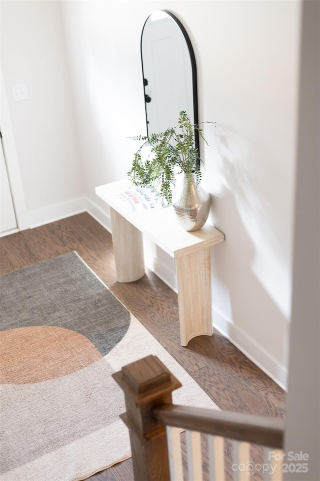 interior space featuring baseboards and wood finished floors