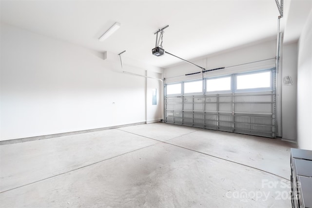 garage with baseboards and a garage door opener