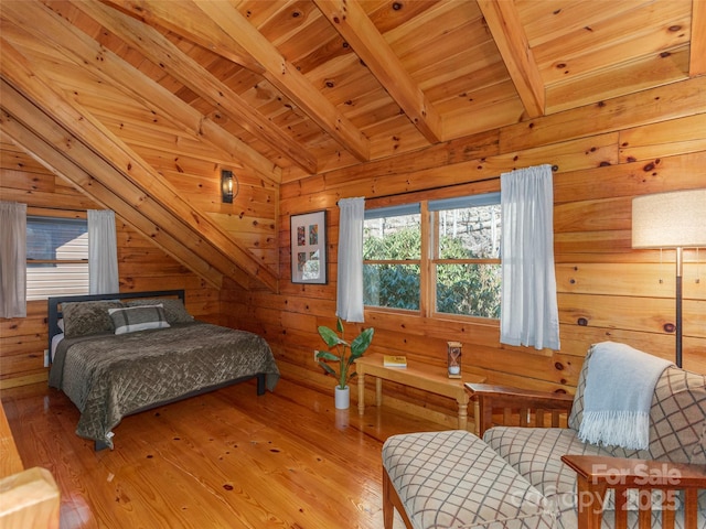 bedroom featuring vaulted ceiling with beams, wooden ceiling, wooden walls, and light wood finished floors