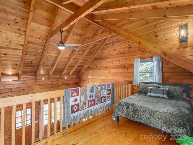 bedroom featuring wood ceiling, wood walls, lofted ceiling with beams, and wood finished floors