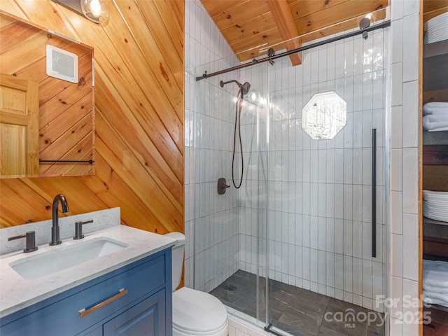 ensuite bathroom featuring toilet, a stall shower, wooden walls, vanity, and ensuite bath