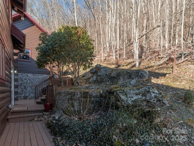 view of yard featuring a wooden deck and stairs