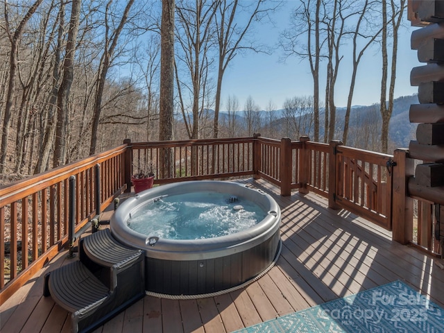 wooden deck featuring hot tub deck surround