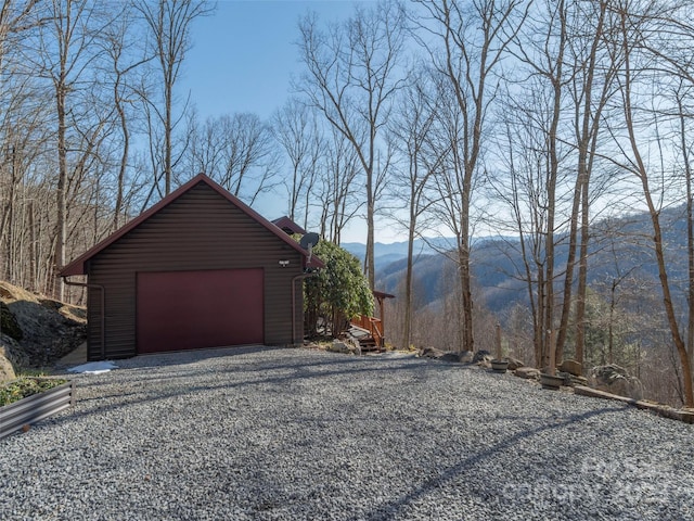 detached garage featuring a mountain view