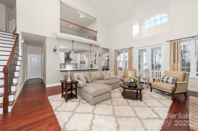 living area with french doors, stairway, wood finished floors, and baseboards