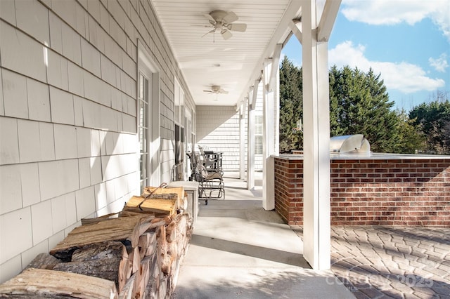 view of patio / terrace with a porch, ceiling fan, and an outdoor kitchen