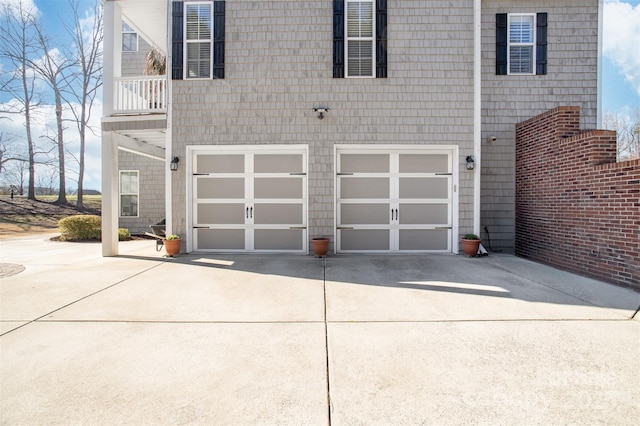 garage featuring concrete driveway