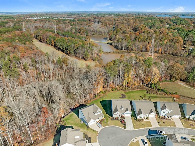 bird's eye view with a water view, a forest view, and a residential view