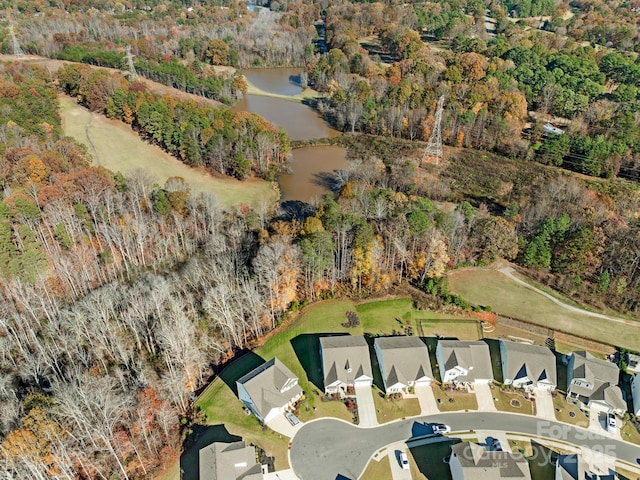 bird's eye view with a wooded view