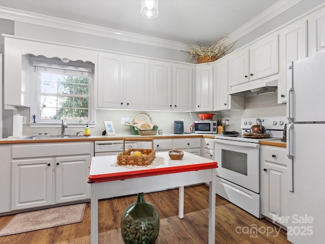 kitchen with white appliances, ornamental molding, under cabinet range hood, white cabinetry, and a sink