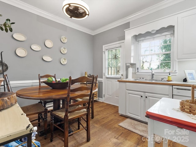 dining space with light wood-type flooring and crown molding