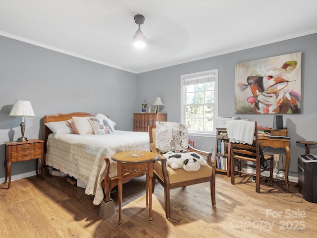 bedroom with light wood-type flooring, ceiling fan, and ornamental molding