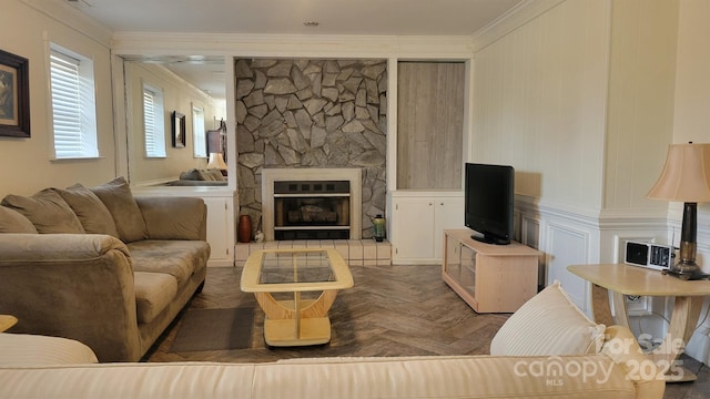 living area featuring a fireplace, ornamental molding, and a decorative wall