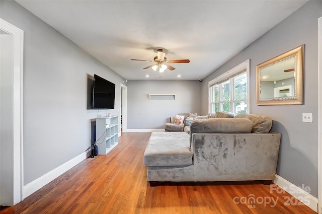 living room featuring ceiling fan, baseboards, wood finished floors, and recessed lighting