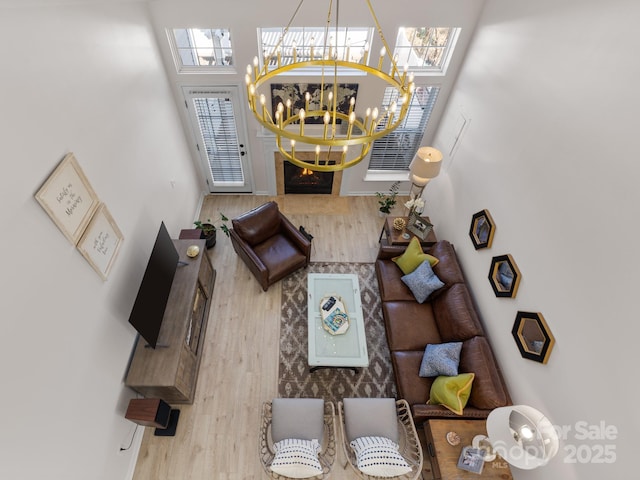 living room with a chandelier and wood finished floors