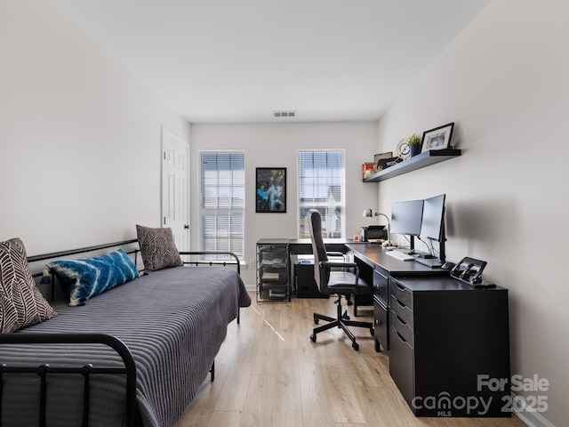 bedroom featuring visible vents, baseboards, and light wood-type flooring