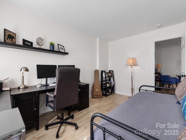 bedroom with baseboards and light wood-style floors