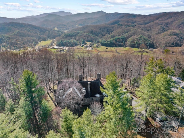 aerial view with a mountain view and a wooded view