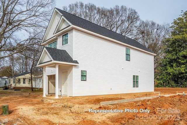 view of home's exterior with a shingled roof