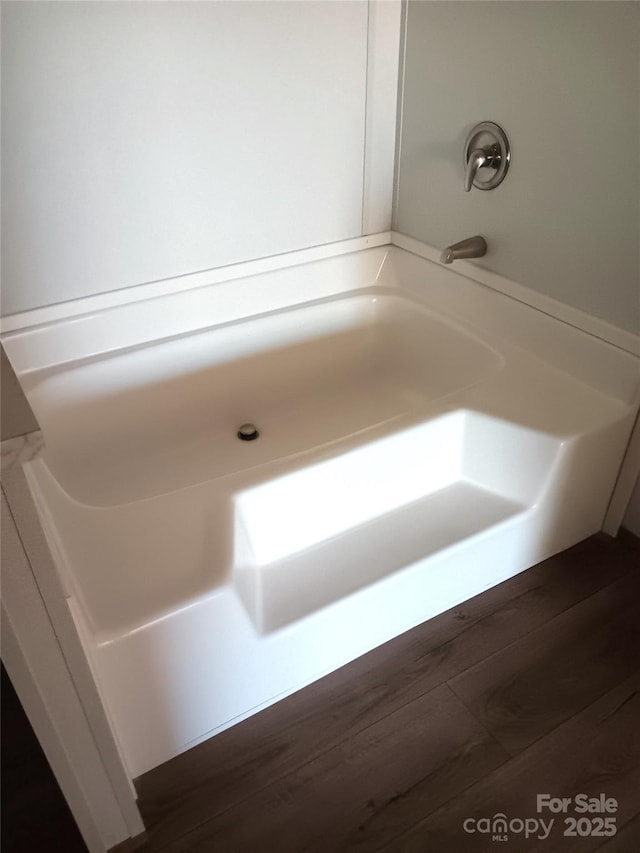 bathroom featuring a tub and wood finished floors