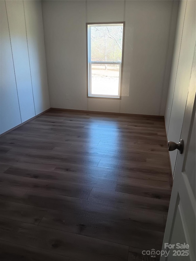 empty room featuring dark wood-style floors