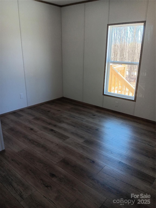 empty room with dark wood-type flooring