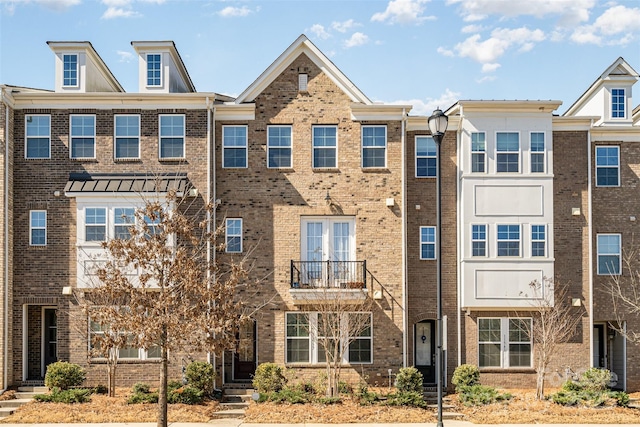 townhome / multi-family property with brick siding