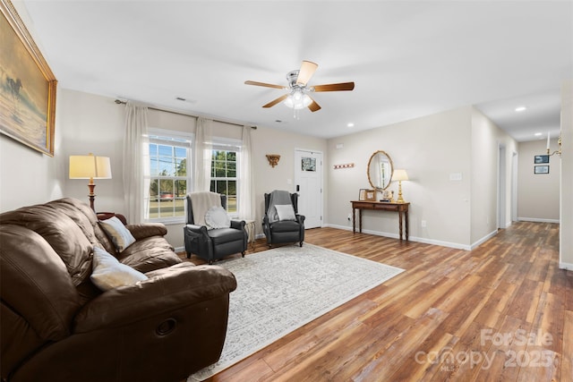 living room with a ceiling fan, recessed lighting, baseboards, and wood finished floors