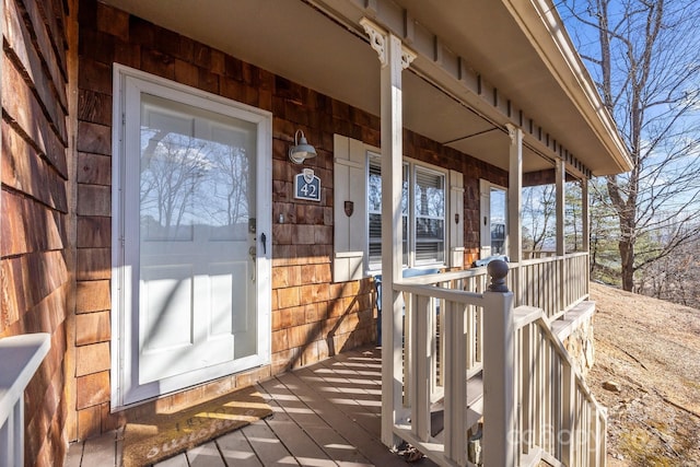 view of exterior entry with a porch