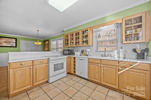 kitchen with white appliances, glass insert cabinets, decorative light fixtures, light countertops, and a sink