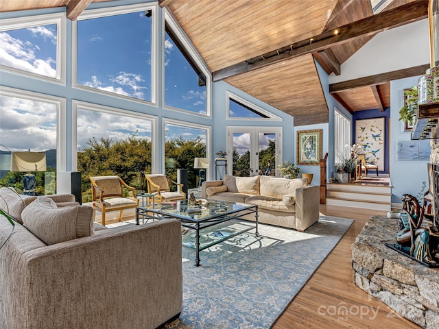 living area with wooden ceiling, wood finished floors, beamed ceiling, french doors, and high vaulted ceiling