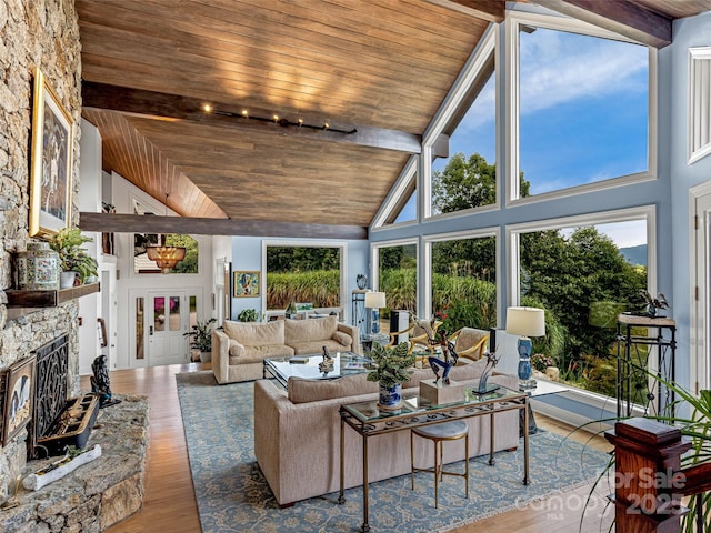 living room with plenty of natural light, light wood-type flooring, and wood ceiling