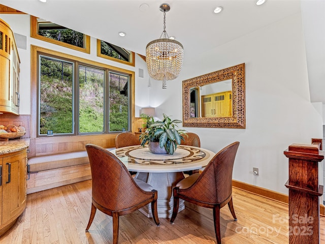 dining room featuring baseboards, light wood finished floors, recessed lighting, and a notable chandelier