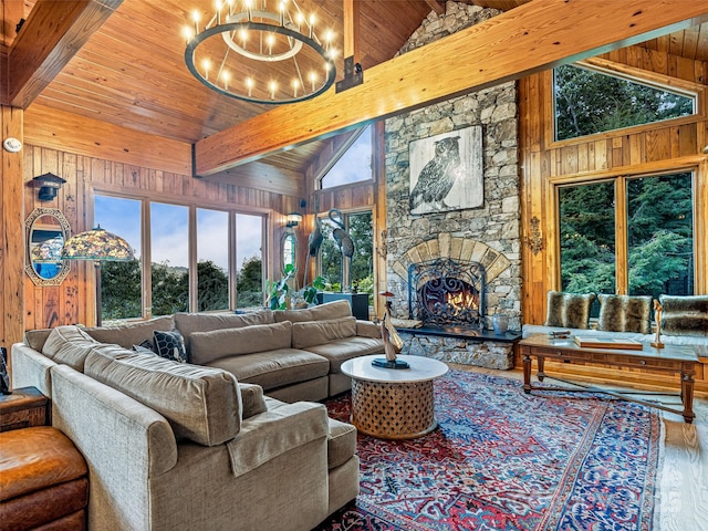 living area featuring a chandelier, wood finished floors, wood ceiling, and wooden walls