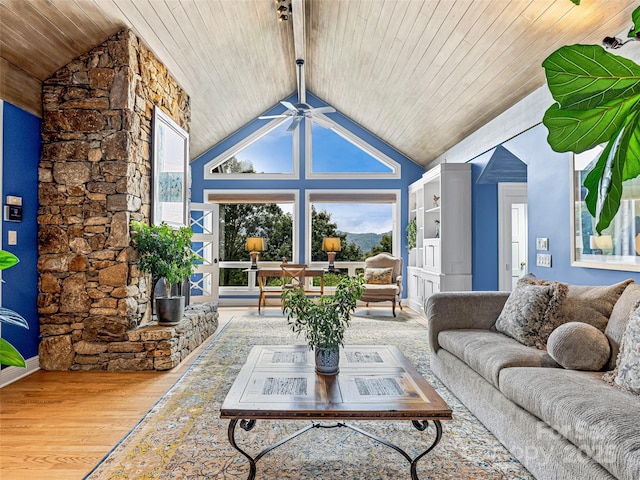 living room featuring a ceiling fan, wood ceiling, a healthy amount of sunlight, and wood finished floors