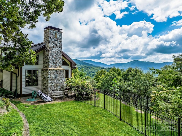 view of yard with fence and a mountain view