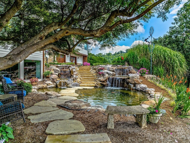 exterior space with a garden pond