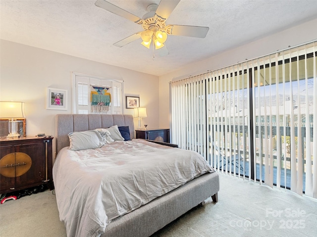 bedroom with light carpet, ceiling fan, access to outside, and a textured ceiling