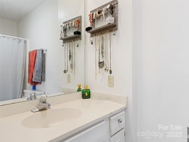 bathroom featuring toilet and vanity