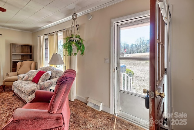 interior space with crown molding, carpet flooring, visible vents, and a healthy amount of sunlight