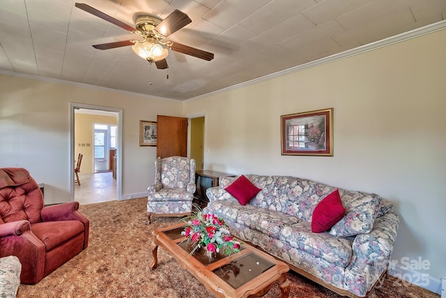 carpeted living room with ceiling fan, baseboards, and crown molding